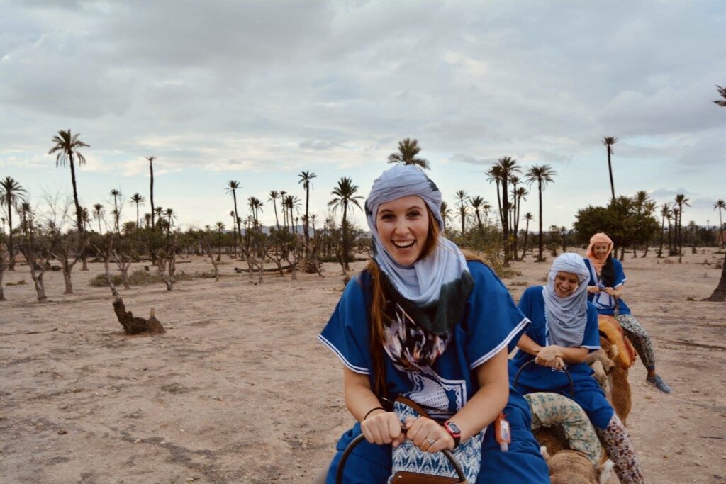 Allie smiles while riding a camel