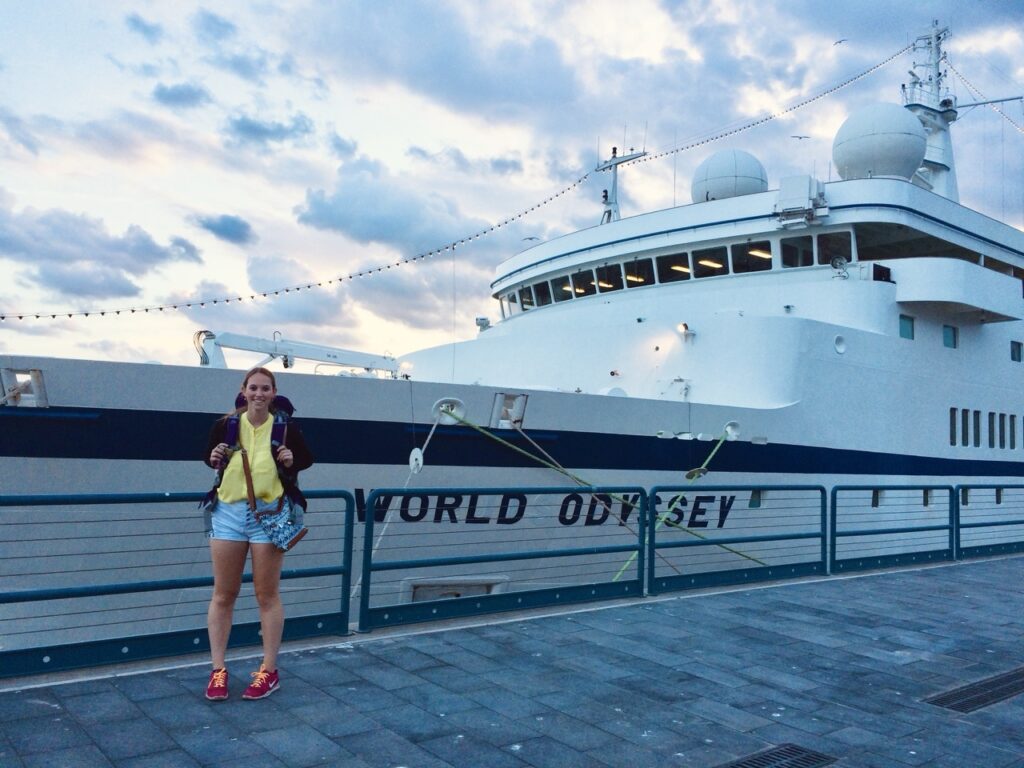 Allie stands in front of the MV World Odyssey cruise ship during Semester at Sea