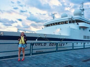 Allie stands in front of the MV World Odyssey cruise ship during Semester at Sea