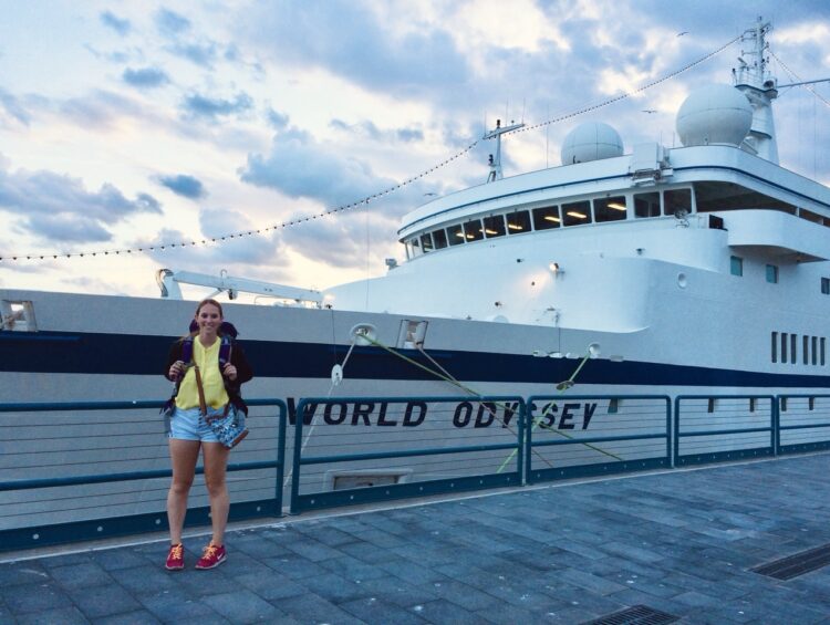 Allie stands in front of the MV World Odyssey cruise ship during Semester at Sea