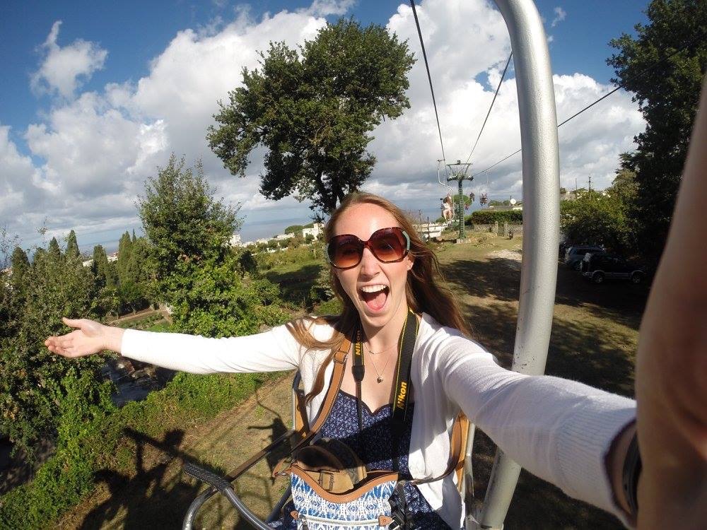 Allie takes a selfie while riding a cable car