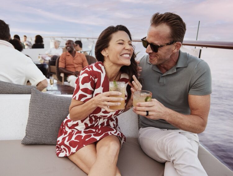 A couple have drinks together at the Sunset Bar on a Celebrity cruise ship