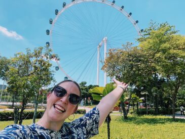 Allie Hubers poses in front of the Singapore Flyer