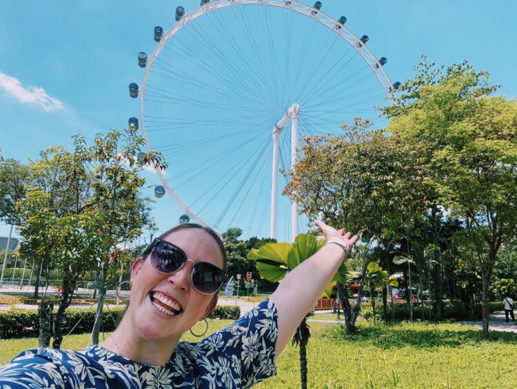 Allie Hubers poses in front of the Singapore Flyer