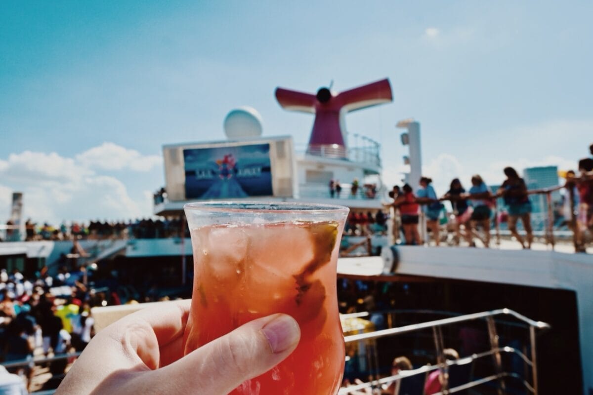 Enjoying a fruity cocktail on the pool deck of a Carnival cruise
