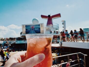 Enjoying a fruity cocktail on the pool deck of a Carnival cruise