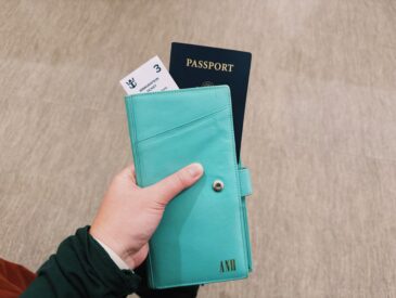 Woman has a passport holder in her hand that shows an immigration ticket and passport