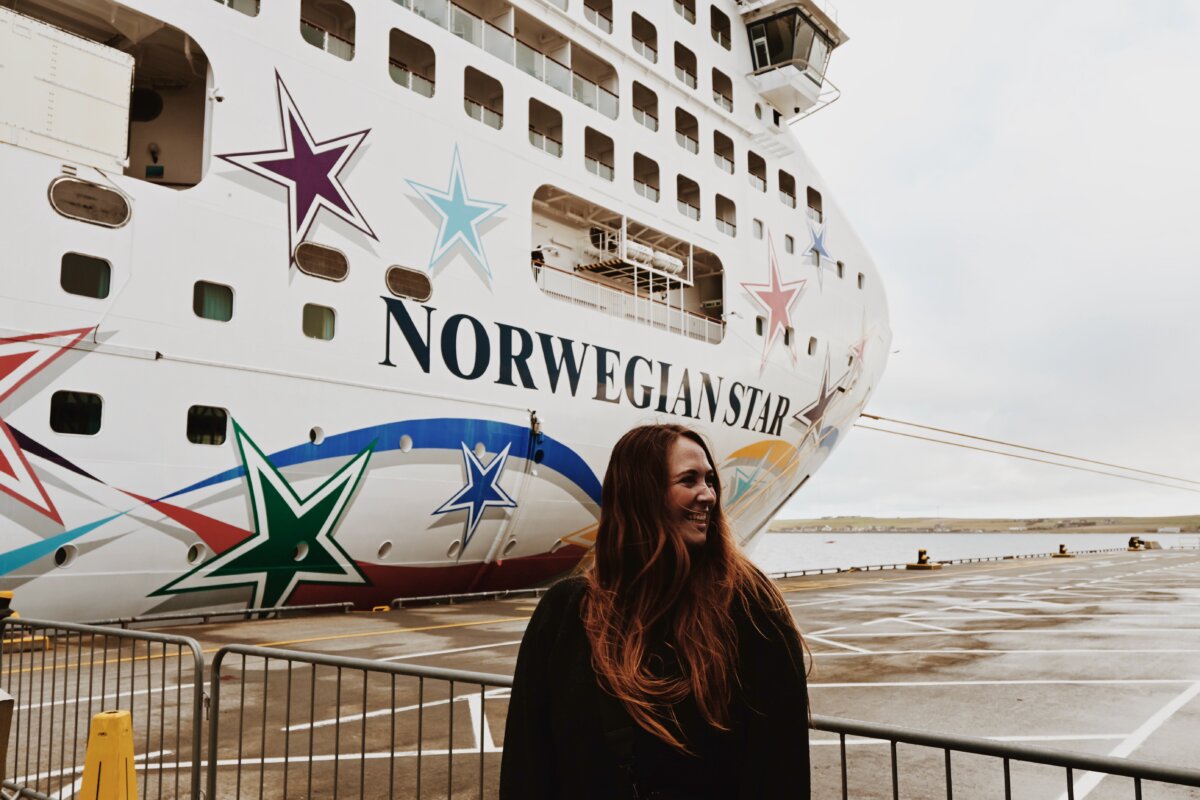 Allie Hubers smiles in front of Norwegian Star