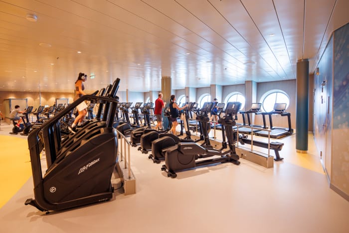 Utopia of the Seas onboard fitness center with plenty of gym equipment