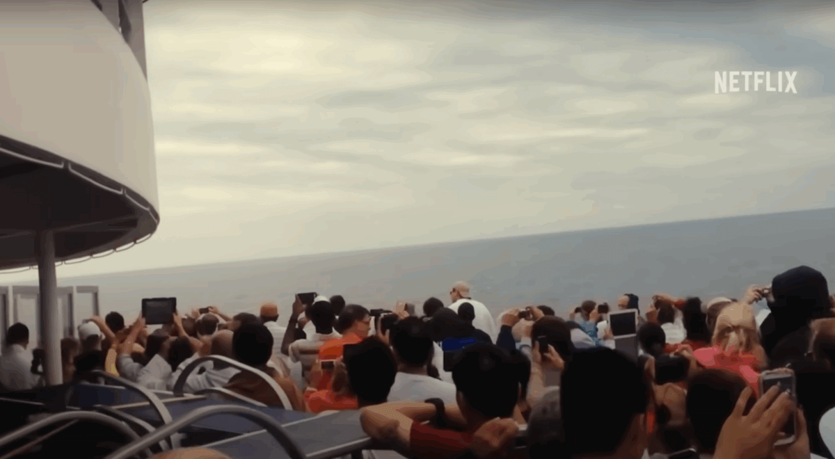 Large crowd of people outside on the poop cruise