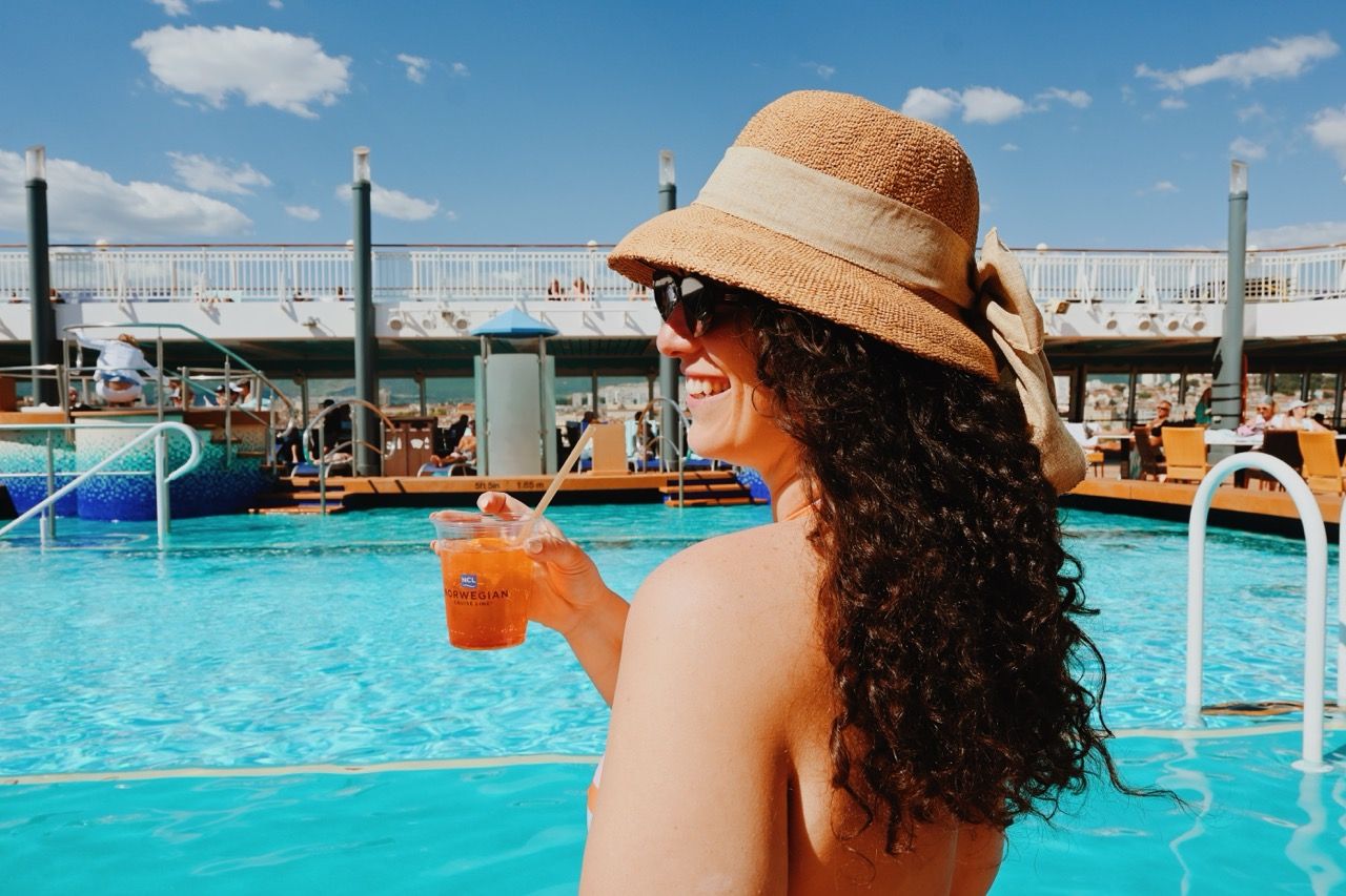 Norwegian Cruise Line Cocktail Poolside with Woman Holding Drink
