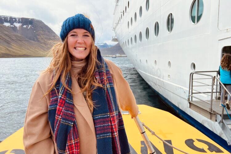 Allie Hubers standing in a tender boat while in Iceland