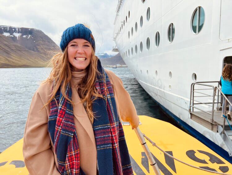 Allie Hubers standing in a tender boat while in Iceland
