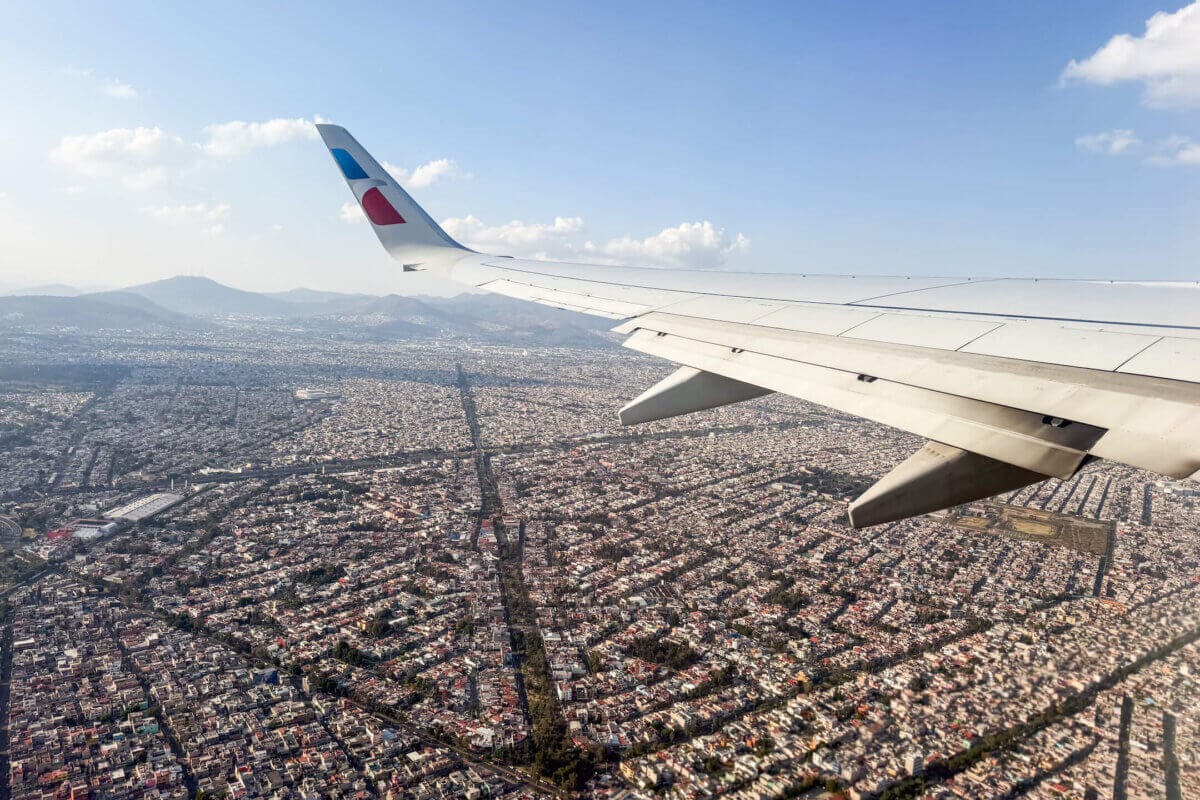 Airplane wing on American Airlines with a view of Mexico City below