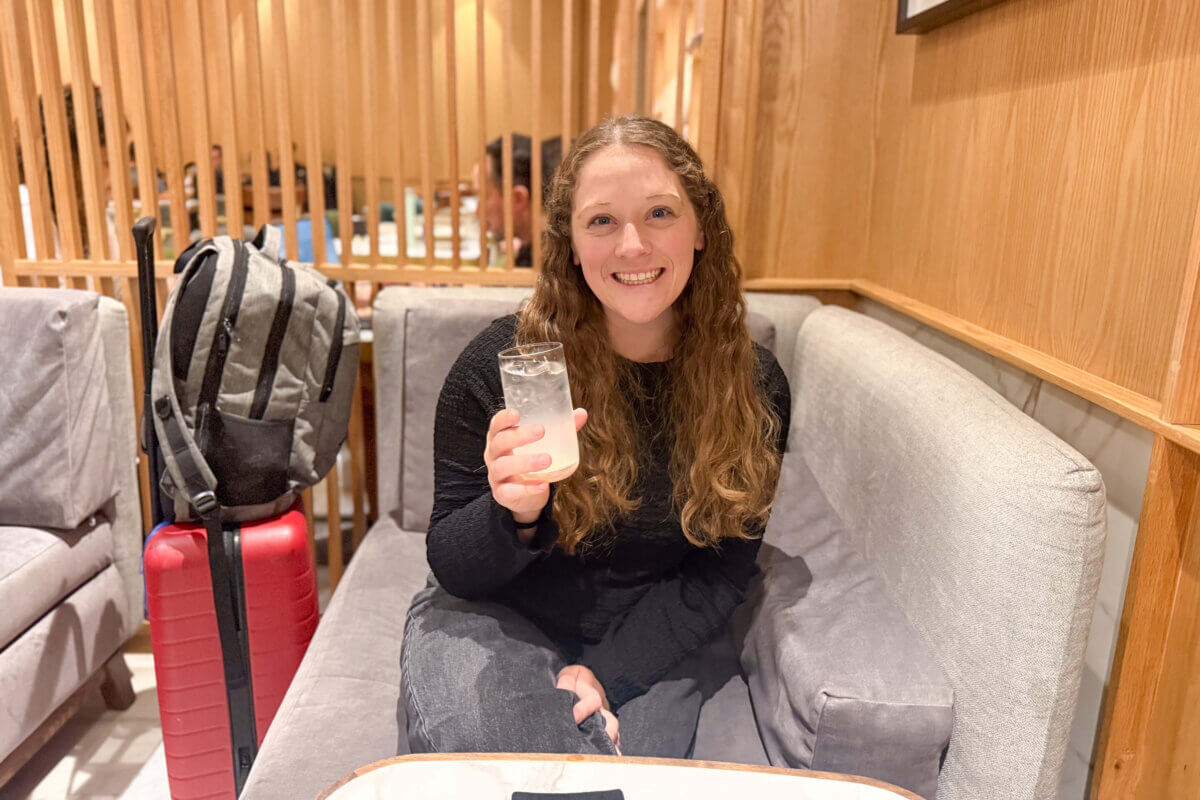 Author sitting with a lemonade in an airport lounge