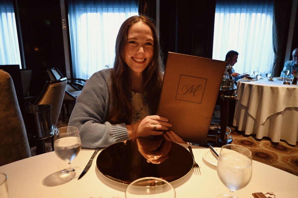 Allie Hubers holding Celebrity Murano Restaurant menu