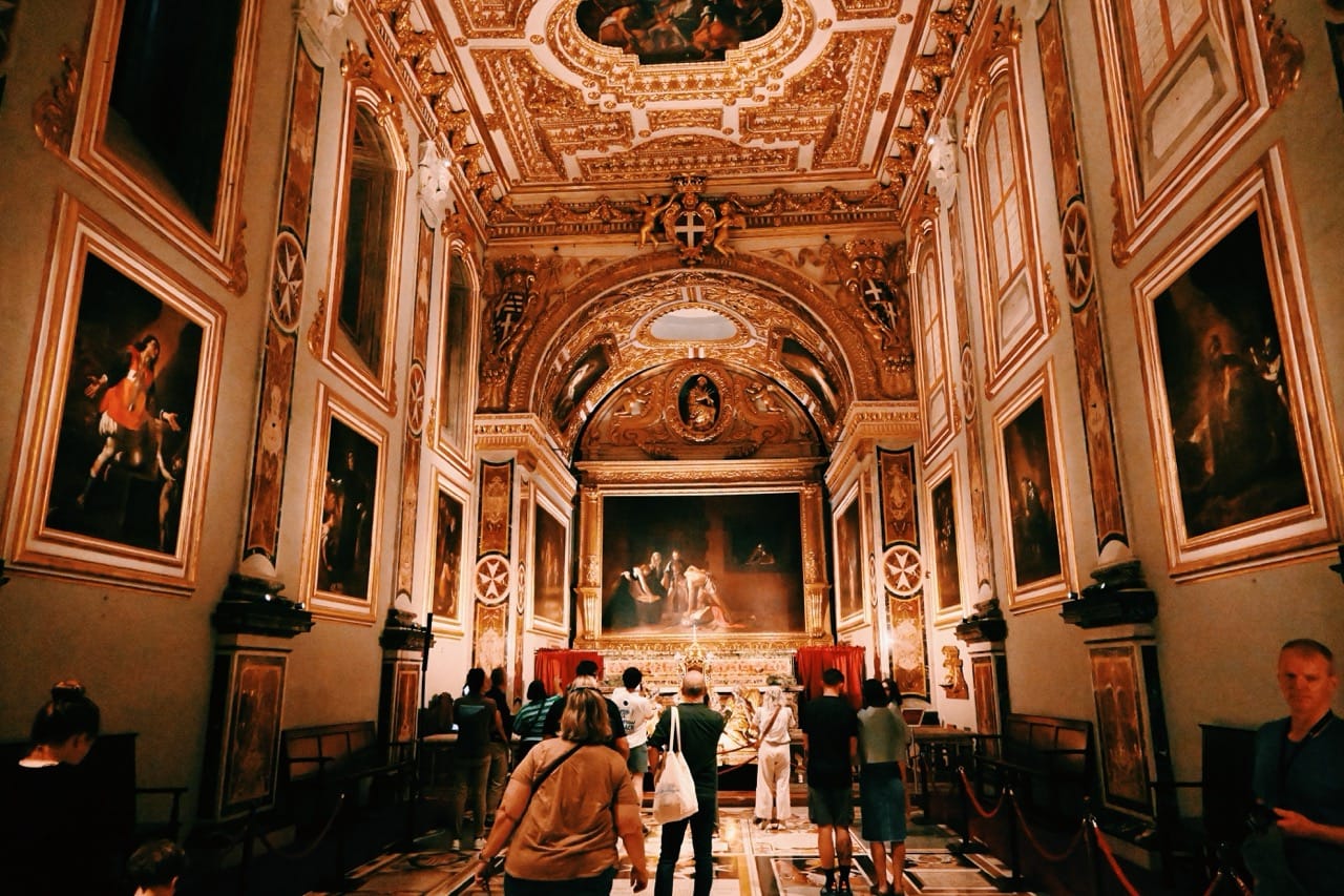 Inside St. John’s Co-Cathedral in Valletta, Malta, featuring gold interiors and Caravaggio artwork