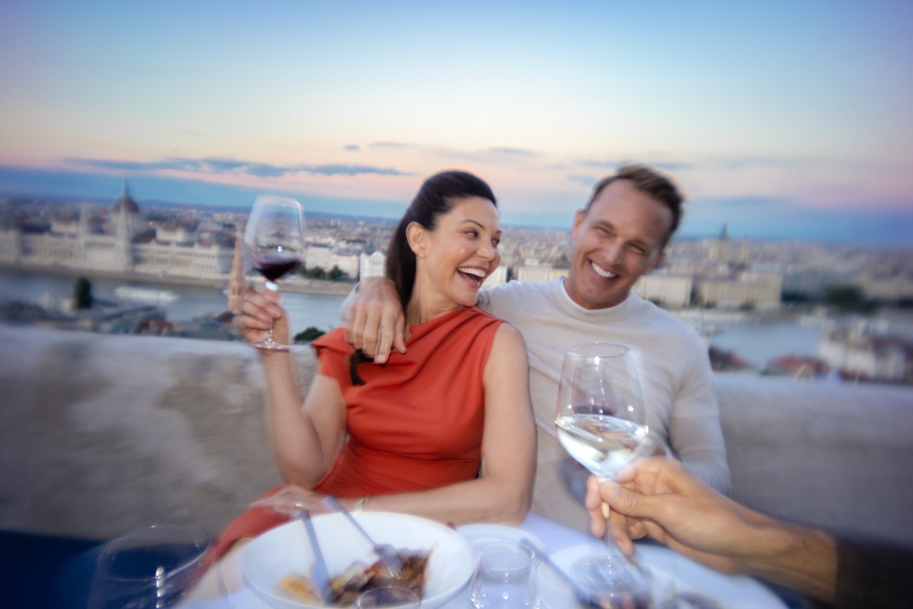 Older adult couple drink wine together in Europe